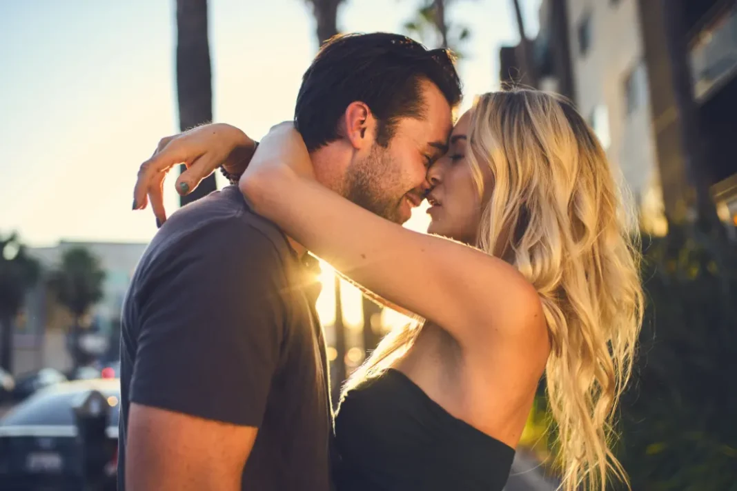 Man and woman kissing outdoor.